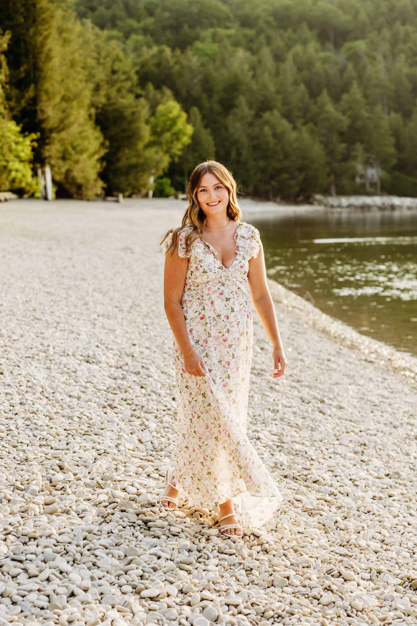 Gorgeous teen girl wearing a dress from Be Beauty Boutique walking along the beach in Door County.