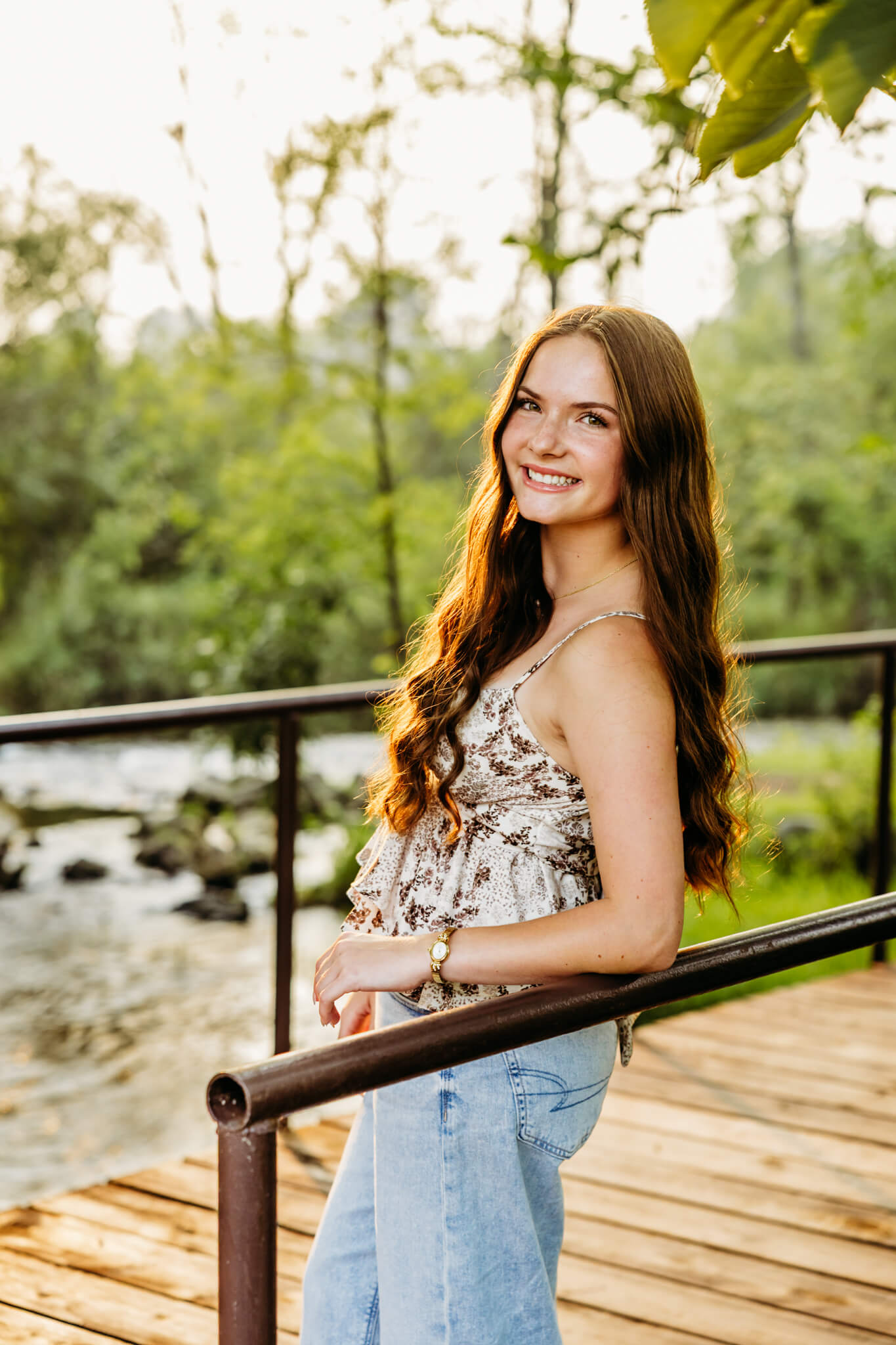 Young lady leaning on a bridge while looking back near Green Bay. 