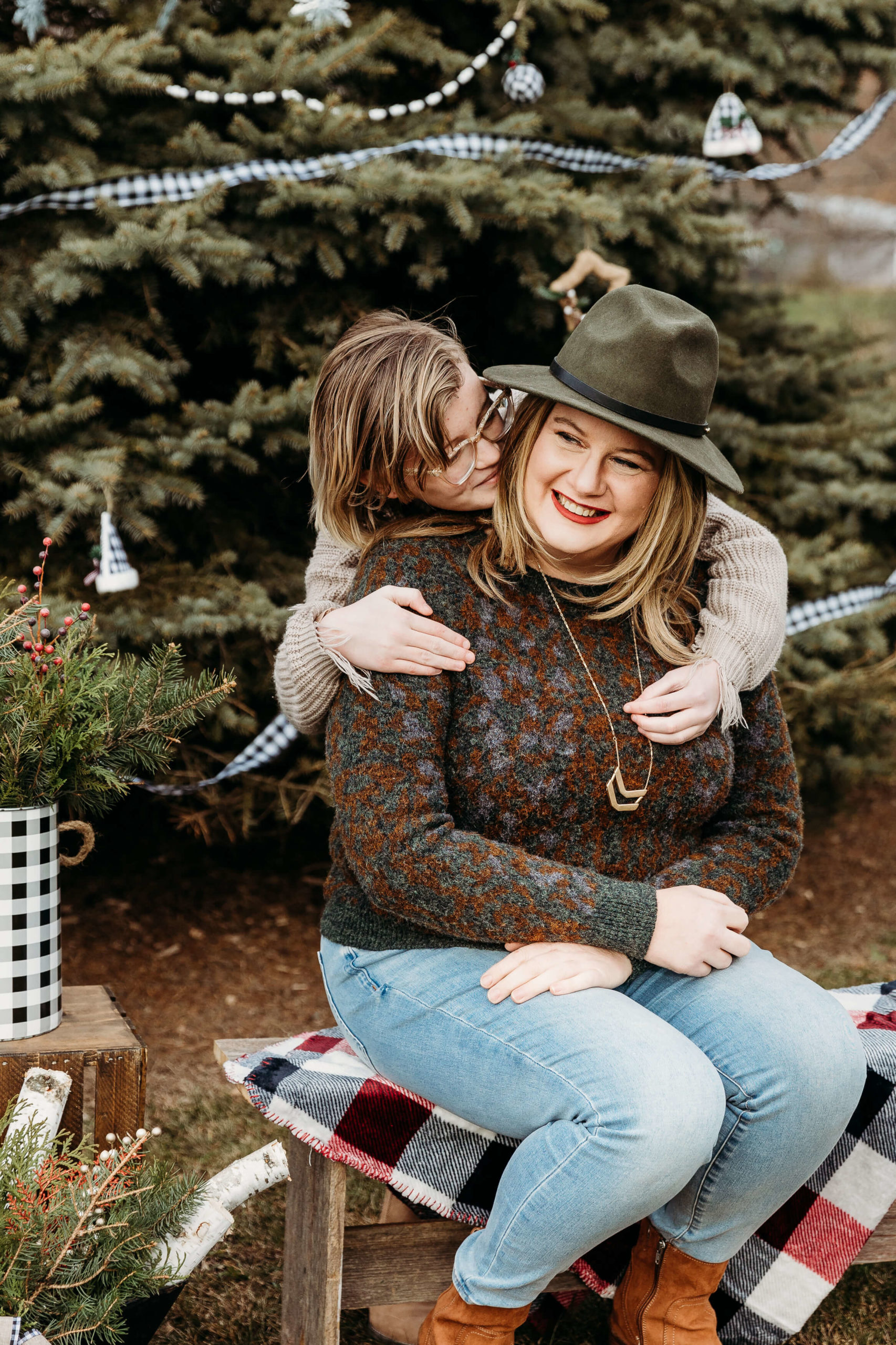 Mother and daughter snuggling together wearing clothes from a boutique in oshkosh wi