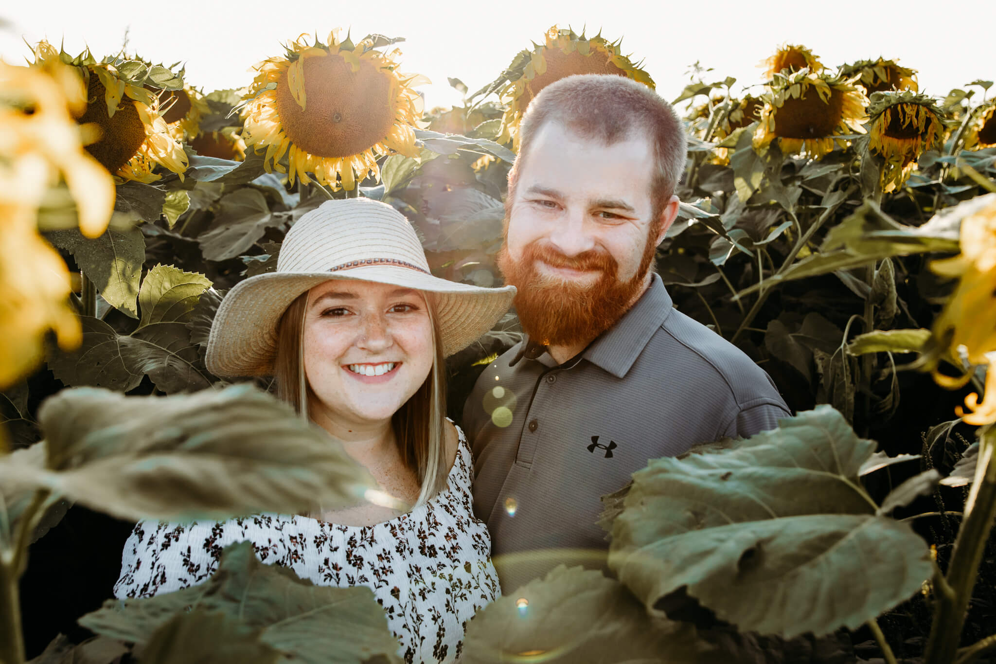 Couple in a sunflower field featured in a blog post about Appleton Nail Salons