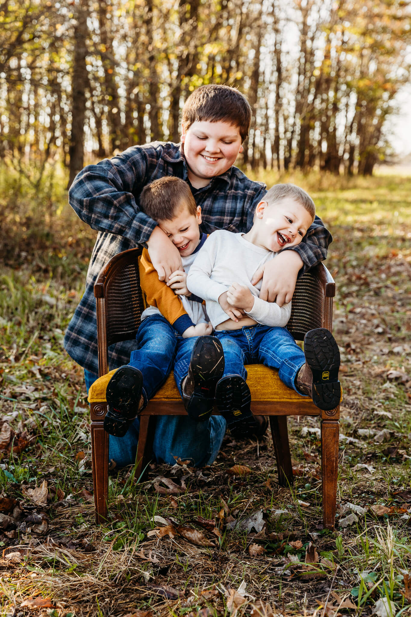 brothers tickling each other during family session by Ashley Kalbus parks in Appleton WI