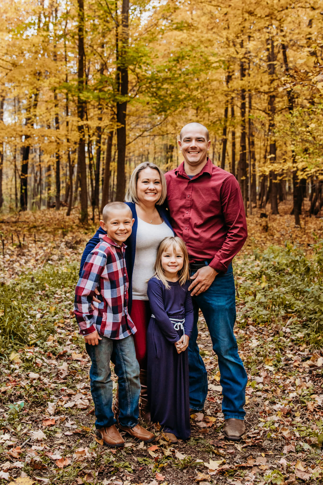 stunning family posing for photo during Fall