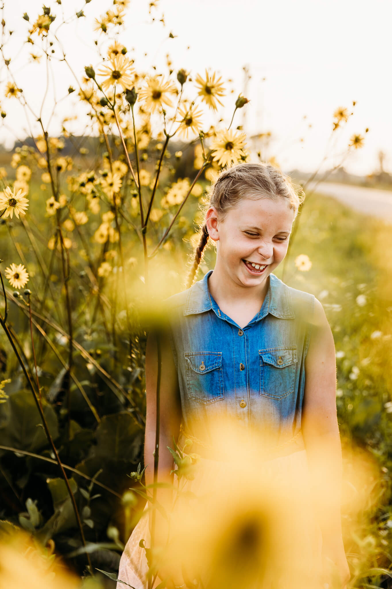 young girl laughing in a field of wild flowers by Ashley Kalbus for blog about Thedacare Pediatrics