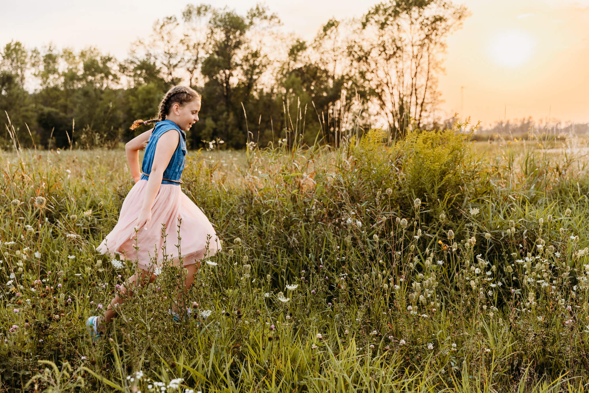 adorable little girl running through a grassy field during a photoshoot for a blog about thedacare pediatrics