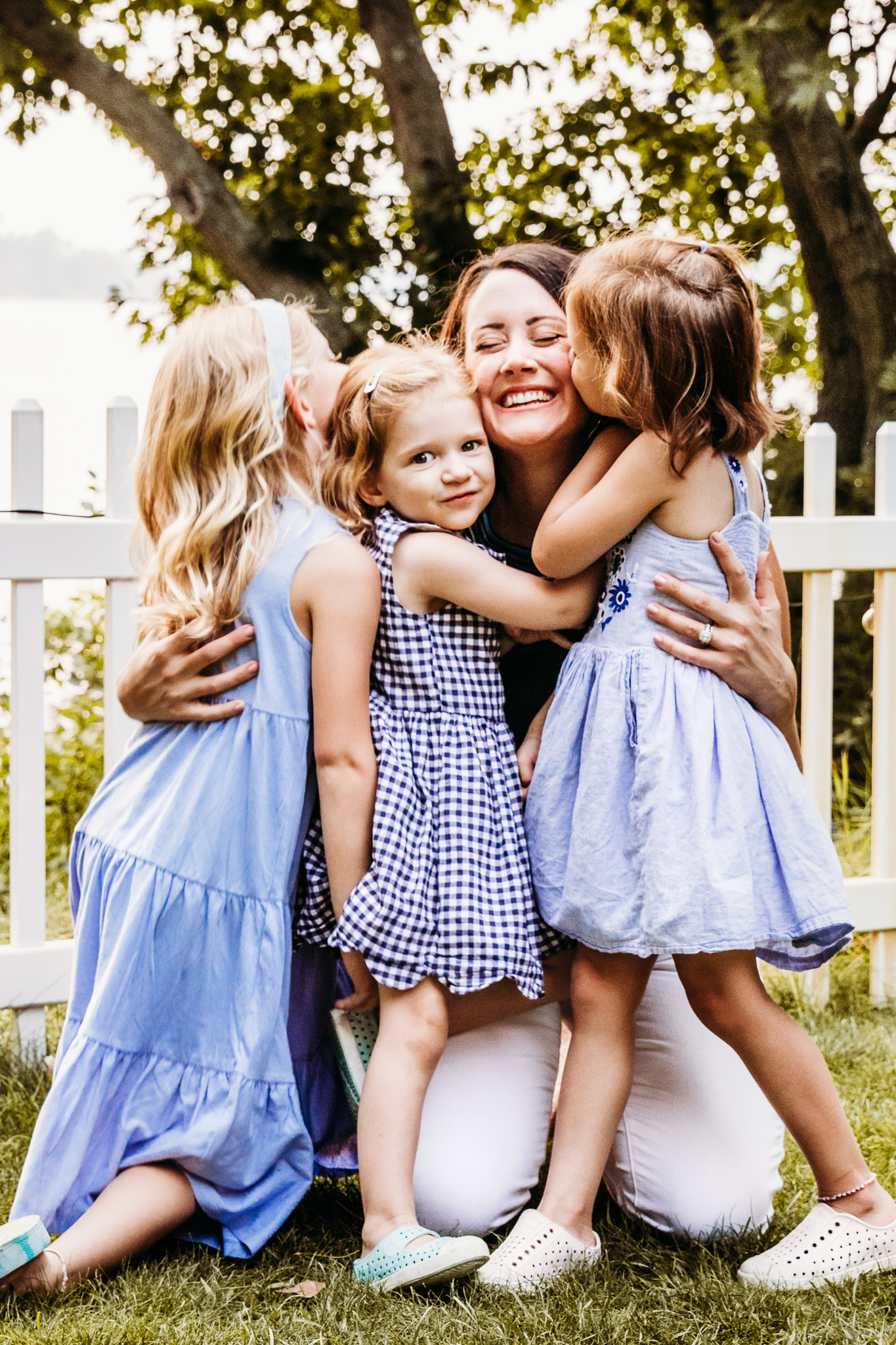 mom hugging her 3 daughters in a yard Build-a-bear Green Bay