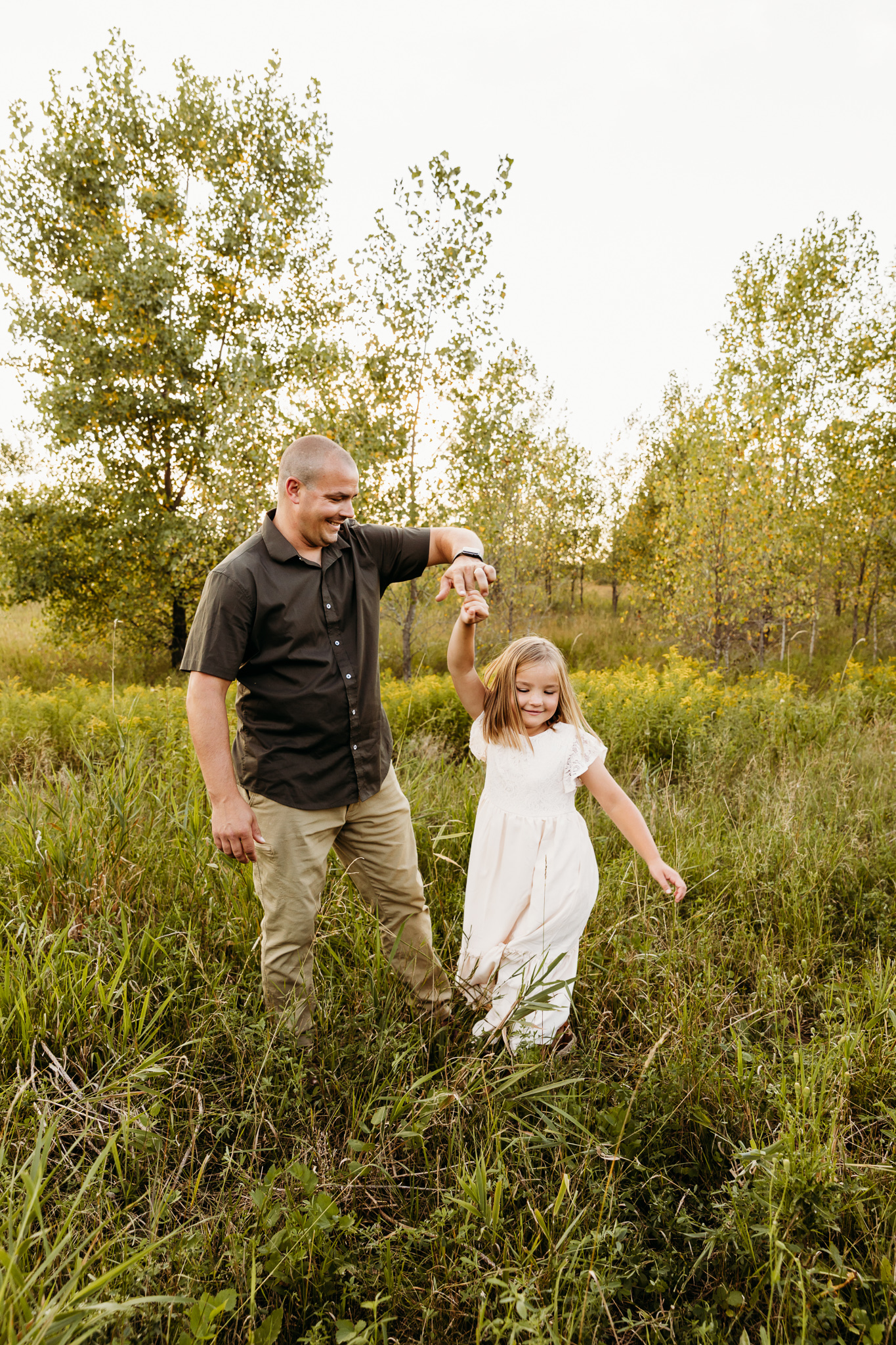 dad and daughter dancing together in a field Once upon a child green bay
