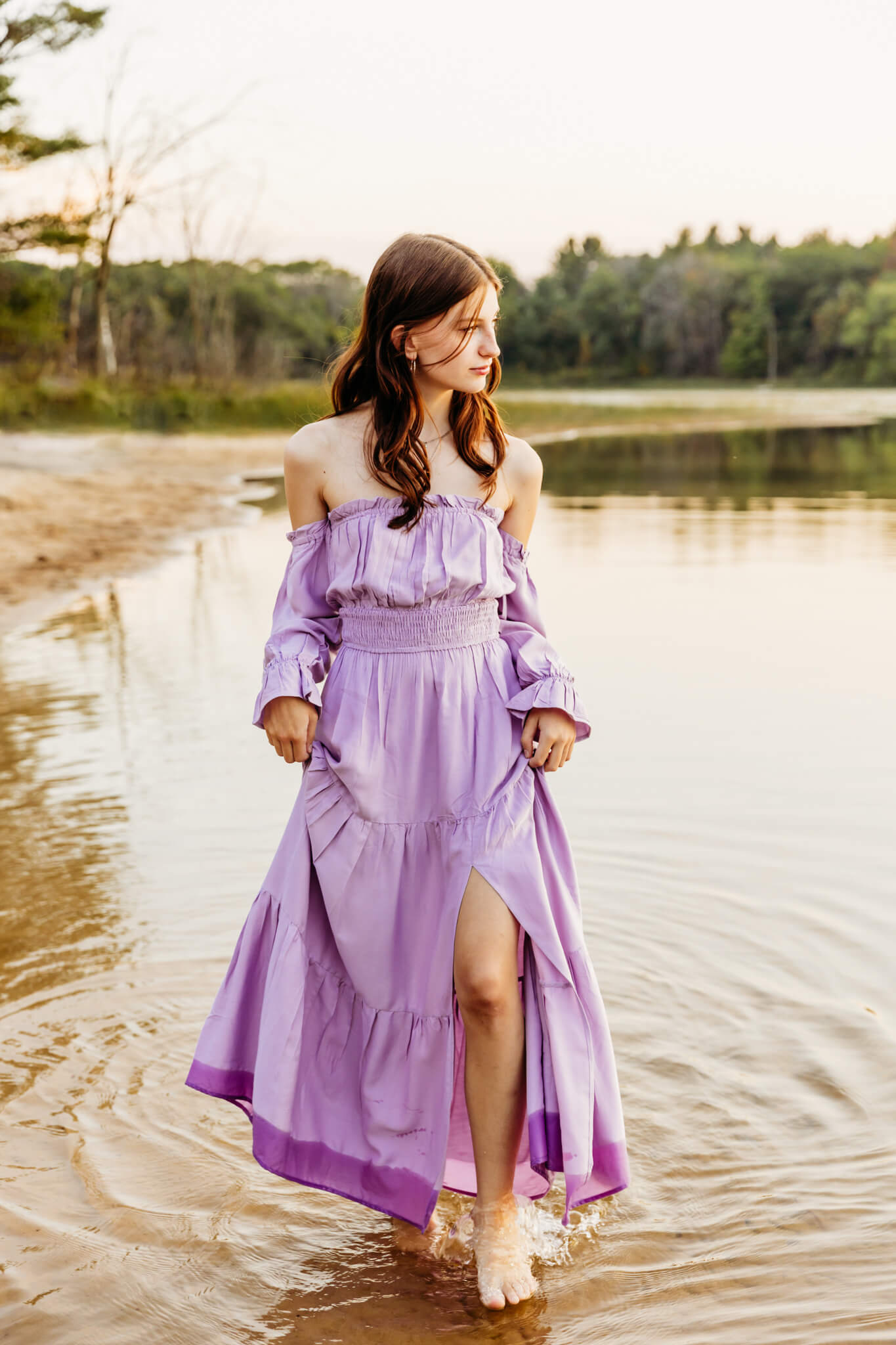 teen girl in a purple dress walking along a beach for a blog post about summer jobs in Kimberly Wi