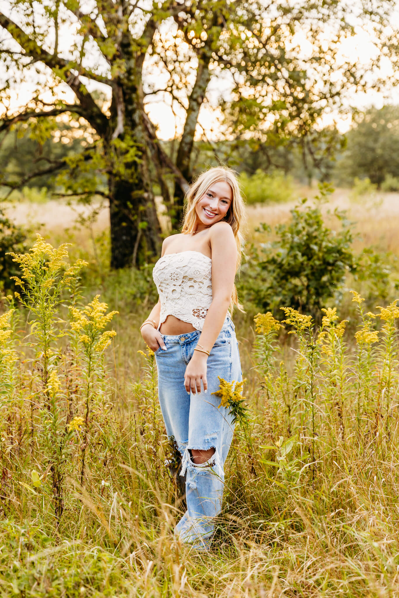 Neenah High School senior walking in a grassy field for her senior photo session