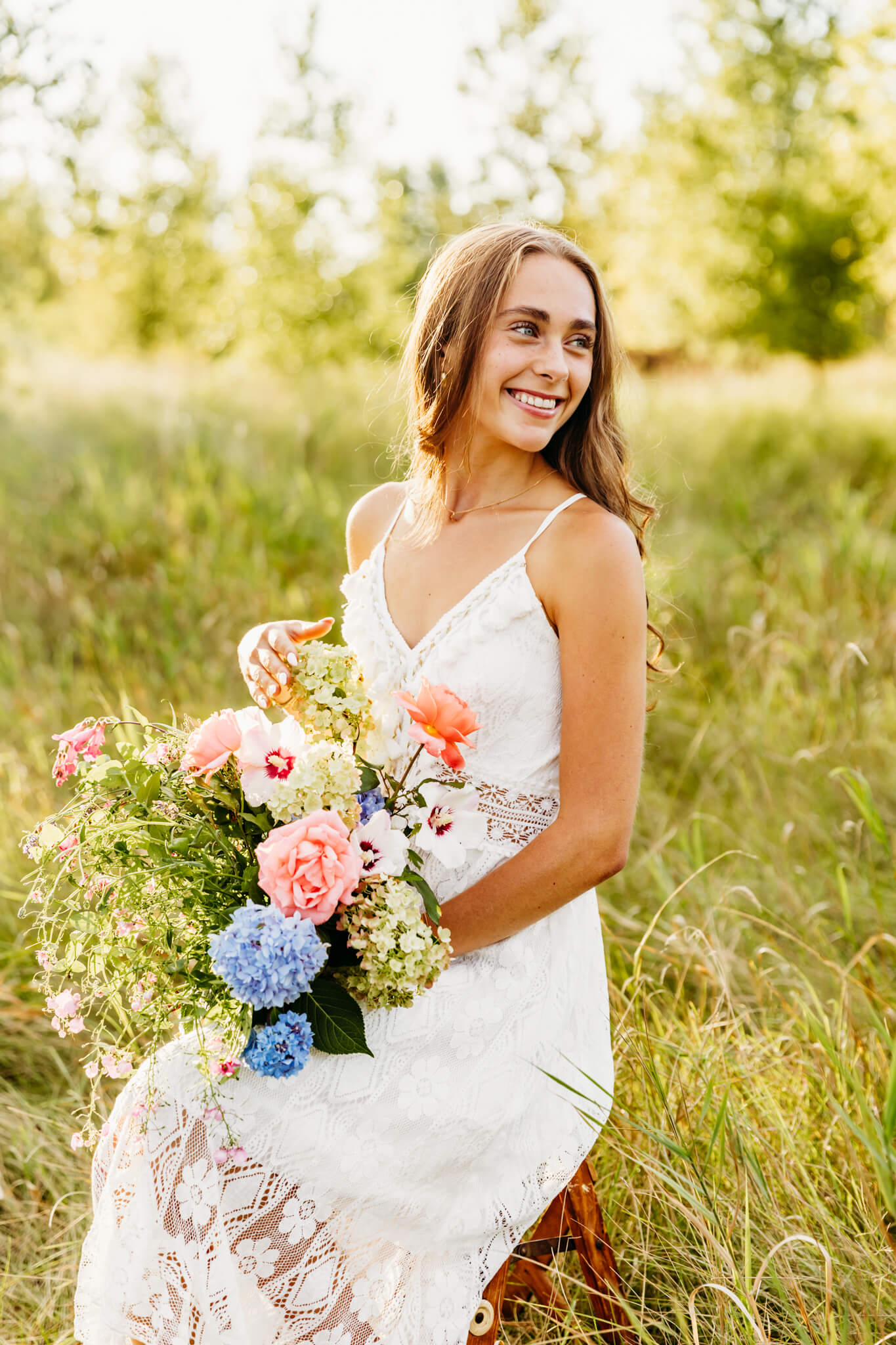 gorgeous teen holding a bouquet made by Holiday Florist in Winneconne