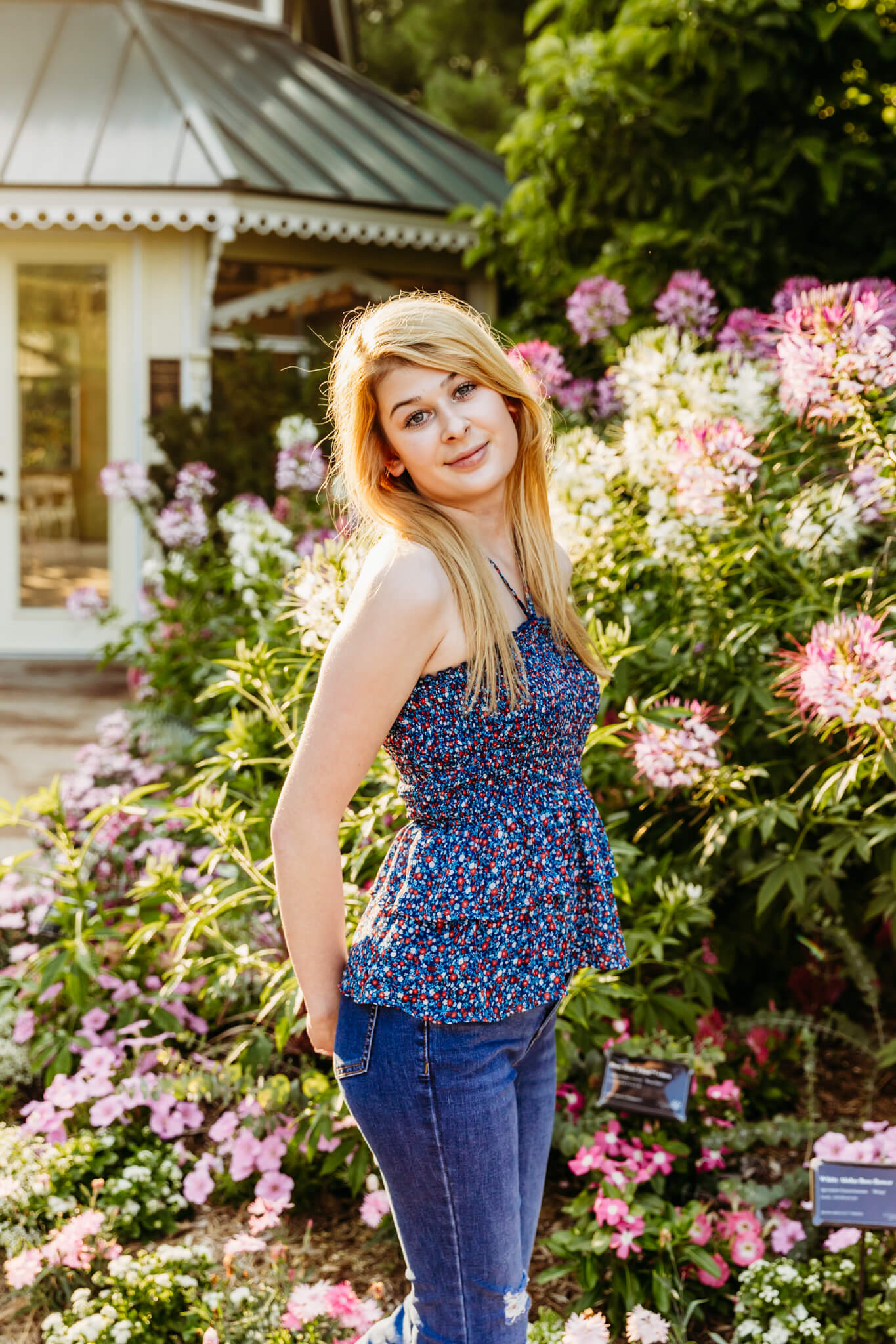 gorgeous young lady standing next to a phlox garden at the Green Bay Botanical Garden