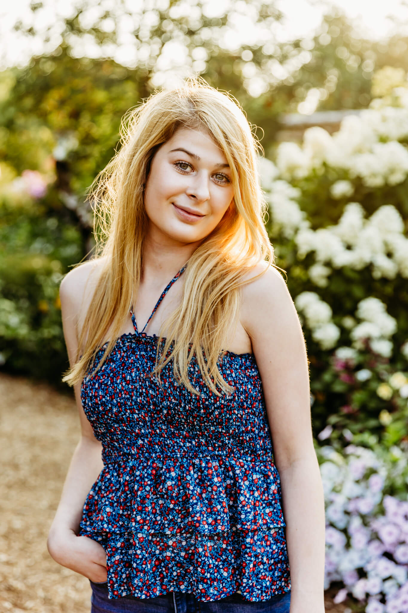 teen girl posing by a hydrangea bush in the Vanderperren English Cottage Garden